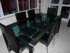 Dining table & 6 chairs Glass top,  black wood & brushed....